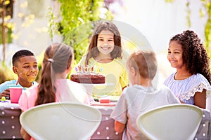 Girl Celebrating Birthday With Friends Having Party In Garden At Home