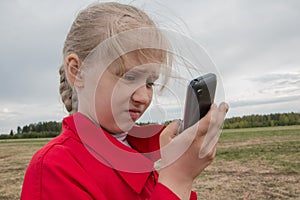 Girl with cell phone and cloudy sky