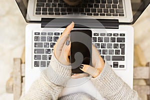 Girl with cell phone and laptop