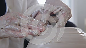 A girl ceramic artist makes a vase on the potter's wheel. Women artists are creating, succeeding, feminism in action