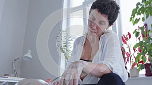 A girl ceramic artist makes a vase on the potter's wheel. Women artists are creating, succeeding, feminism in action