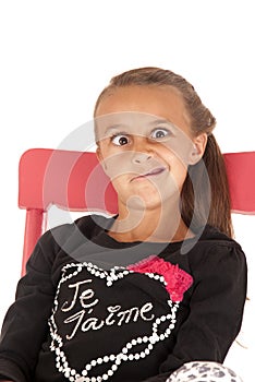 Girl in chair pulling a funny face in black shirt