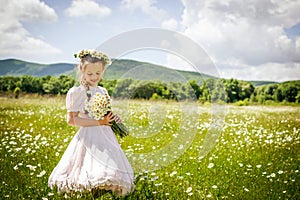 Girl with chamomile wreath in summer field
