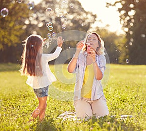 Girl chase soap bubbles in park