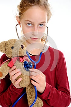 Girl check-up teddy bear with stethoscope