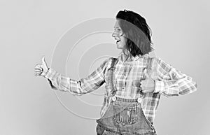 girl in checkered shirt and jeans. casual fashion style. attractive beauty with short brunette hair. express human