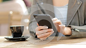 Girl checking content on smart phone in a coffee shop