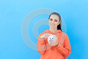 Girl Checking Piggy Bank for Money Savings