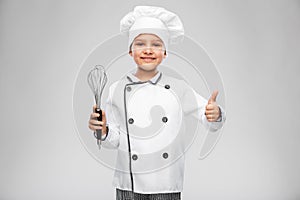 girl in chef& x27;s toque with whisk showing thumbs up
