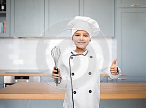 girl in chef& x27;s toque with whisk showing thumbs up
