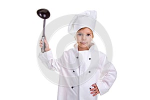 Girl chef white uniform isolated on white background. Holding black ladle up with another hand on the waist. Looking at