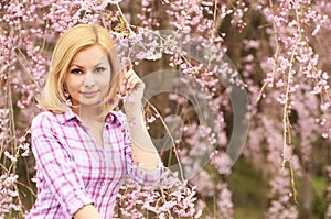 Girl with Cherry Blossom. Beautiful Blonde