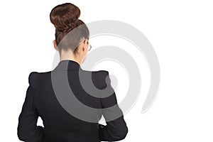 Girl with a chignon in a black suit standing with