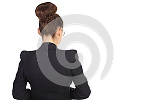 Girl with a chignon in a black suit standing with photo