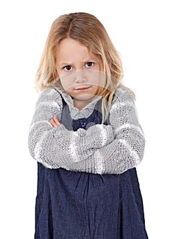 Girl, child and angry in portrait with arms crossed, frustrated and stress, emotion and frown on white background. Youth