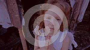 Girl child on the background of a burned-out house.