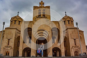 A girl with a child on the background of St. Gregory the Illuminator Church in the center of Yerevan, May 2, 2019