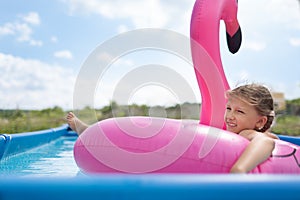 Girl child bathes in the pool