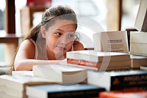 Girl child, books in library and education, story for knowledge or entertainment with customer in bookshop. Learning for