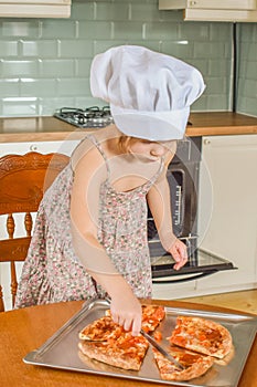 The girl child cooks pizza in the oven photo without filter