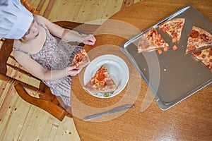 The girl child cooks pizza in the oven photo without filter