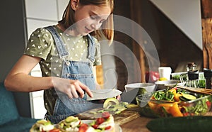 Girl with vegetables at kitchen photo