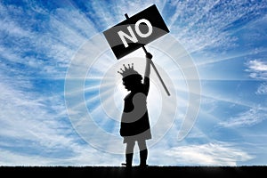 Girl child egoist with a crown on his head holds a poster with the word no photo