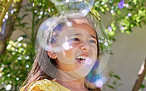 Girl, child and happy with bubbles in garden for playing, excited or outdoor on vacation in summer. Kid, smile and soap