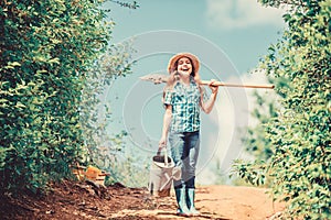 Girl child hold shovel watering can. Spring gardening checklist. Little helper. Watering tools that will solve dry yard