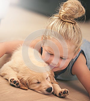 Girl child hug her puppy, relax at home and happy with sleeping golden retriever dog, friends and peace. Pet care, love