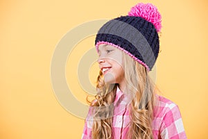 Girl child with long, blond hair smile on orange background