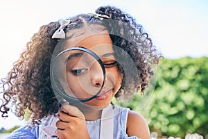 Girl child, magnifying glass and inspection in garden, backyard or park in science, study or outdoor. Young female kid