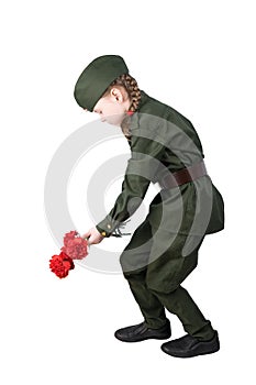 girl child in military uniform lays red flowers isolated on white