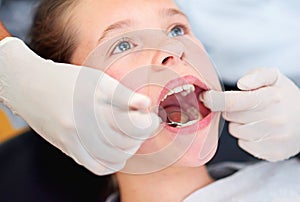 Girl, child and mirror for inspection at dentist for healthcare with dental tool, consultation and checkup for oral