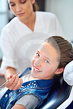 Girl, child and portrait at dentist for healthcare with dental tool, consultation or mouth inspection for oral health