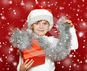 Girl child portrait with gift box on red, christmas holiday concept
