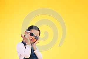 Girl, child and portrait with sunglasses in studio for confidence, cool and fun attitude. Face, space and young kid with