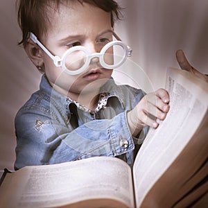 Girl child reading a magic book. Education, knowledge, wisdom,