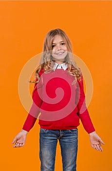 Girl child with smile in red sweater and blue jeans