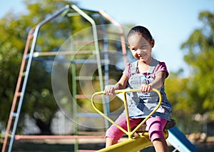 Girl child, smile and seesaw at park, school or outdoor in spring for playful games, adventure or freedom. Kid