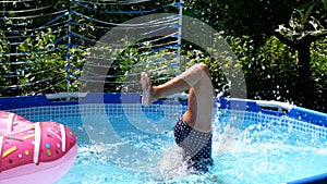 Girl child in swimming mask dive in outdoor pool on sunny summer day, diving