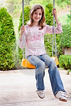 Girl child at swing chair