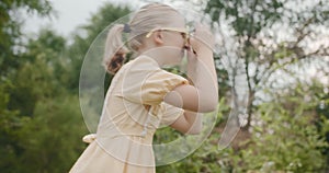 girl child take pictures in the park outdoors kids dream concept happy