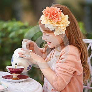 Girl, child and tea party or outdoor play for fantasy fancy game for snack, birthday or beverage. Kid, youth and smile