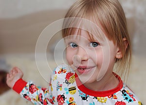 Girl children on bed in pajamas.