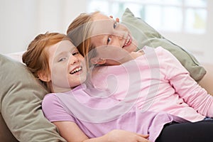 Girl children, sisters and couch portrait, bonding with love and care at family home, trust and support. Friends, smile