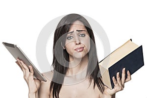 Girl choosing from tablet and book