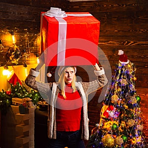 Girl with christmas gift box. Girl with christmas hat and many gifts celebrating the christmas holidays having big box