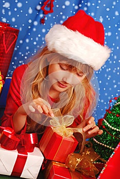 Girl and christmas gifts with snowy background