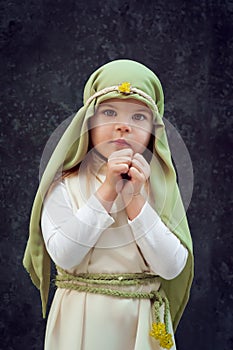 Girl in a Christmas outfit. Attire for the reconstruction of the history of the birth of Jesus Christ. Girl in biblical costume,